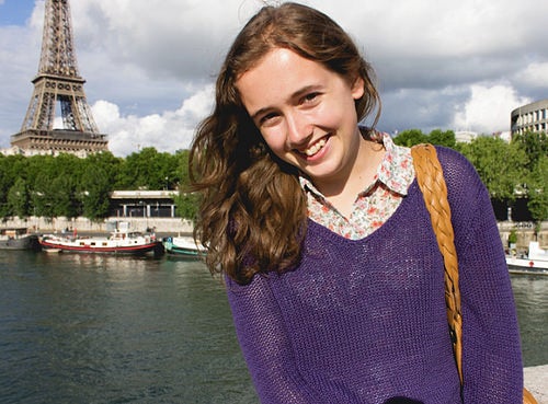 Author Stephanie by the banks of the Seine river in Paris. The Eiffel Tower is in the background.
