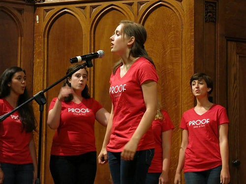 Author Stephanie at the microphone during a &quot;Proof of the Pudding&quot; performance.