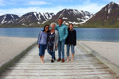 Jinchen with her Host Family in Iceland, with the fjord and mountains behind them.