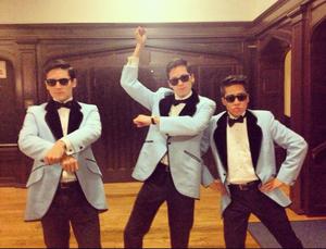 Three students in costume as PSY, all doing the &quot;Gangnam Style&quot; dance.