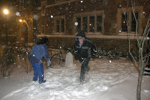 Yale students having a snowball fight during a snowstorm.