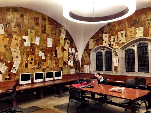 The Yale Daily News boardroom, wallpapered in old YDN covers.