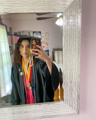 Paulina Pimentel-Mora taking a selfie in her cap and gown. 