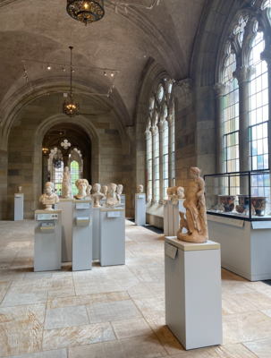 Interior location full of Ancient Greek busts and statues illuminated by strong daylight