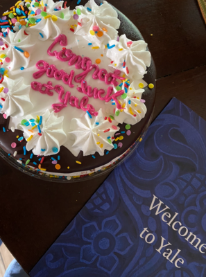 A cake with frosting saying Congrats Good Luck at Yale