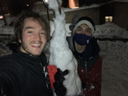 two friends near snow tower