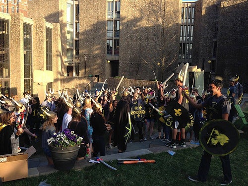 Stilesians in their Medieval garb rallying en masse outside a residential college.