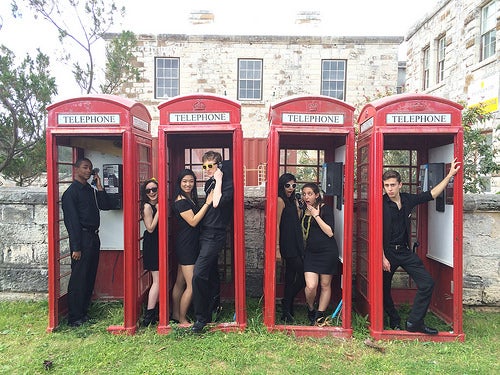 Members of the &quot;Mixed Company&quot; vocal group strike poses inside a row of phone booths.