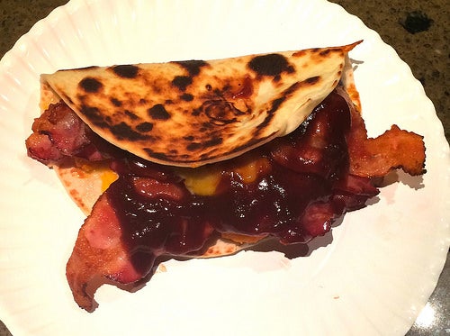 The contents of a Bacon Barbeque Quesadilla spilling out onto a plate.