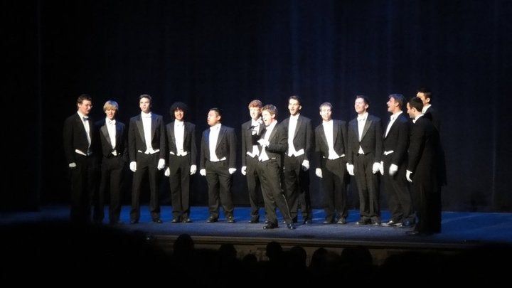 An all-male A Capella vocla group performing in tuxedos.