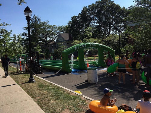 People with inflateable tubes line up to go down the slide.