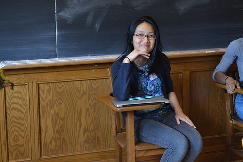 Jinchen at the Symposium, holding back a laugh as she poses for a picture.