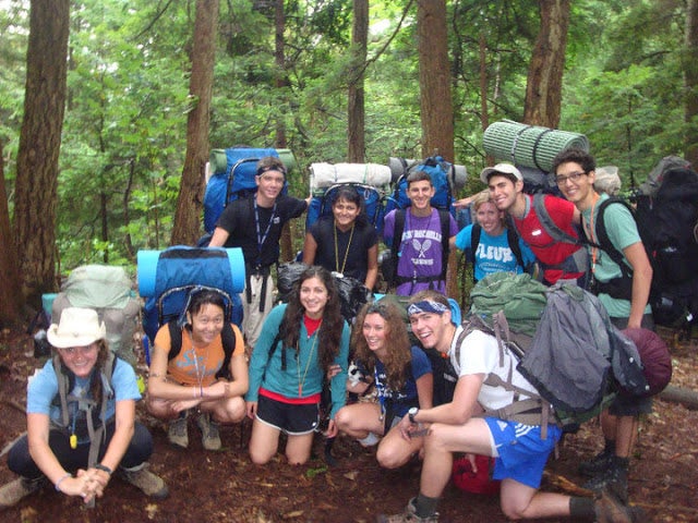 FOOT participants pose on the trail with their hiking gear.
