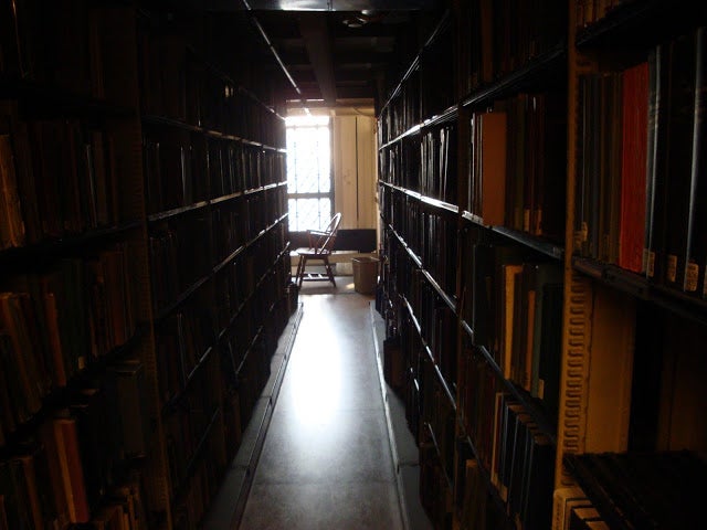 An aisle between two shelves at Sterling Memorial Library.