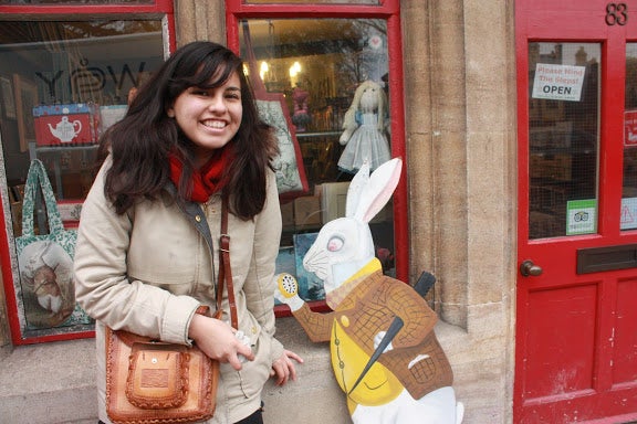 Author Michelle smiling with a carboard standee of the white rabbit from Alice in Wonderland.