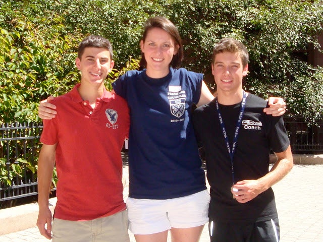 A Freshman Counselor with her arms around two new Freshman residents.