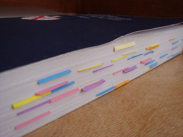 The Author's &quot;Blue Book&quot;, marked with a large amount of multicolored sticky notes.