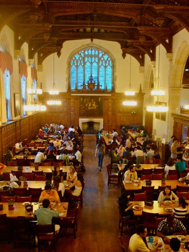 A crowded resident college dining hall.