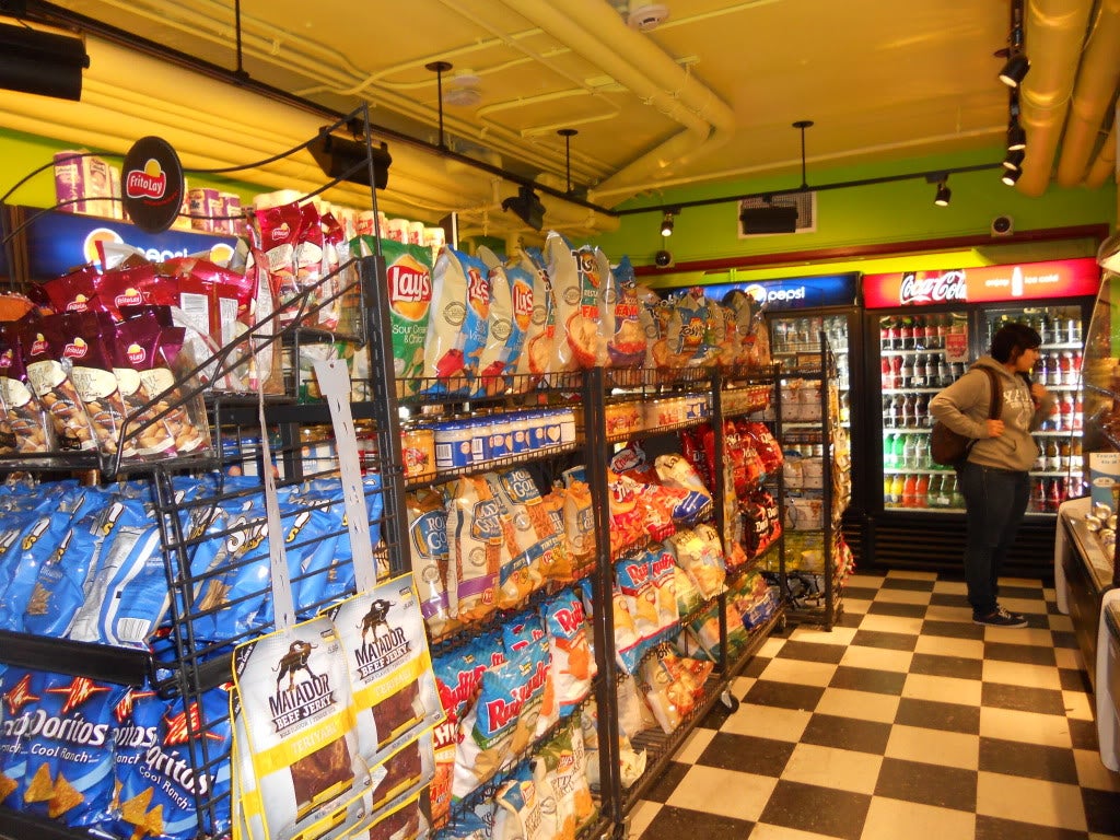 A convenience store aisle fully stocked with chips and snacks.