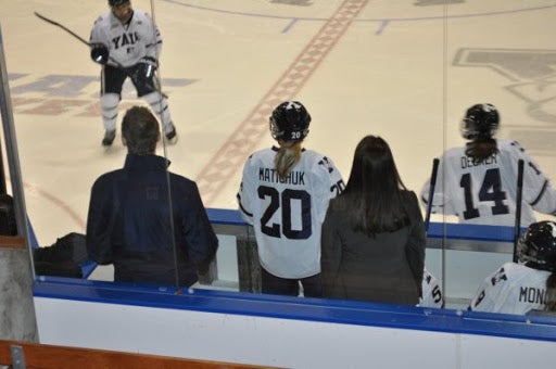 Yale Hockey players on the bench.