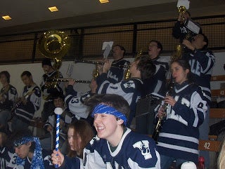 The Yale Precision Marching Band playing in Yale Hockey jerseys.