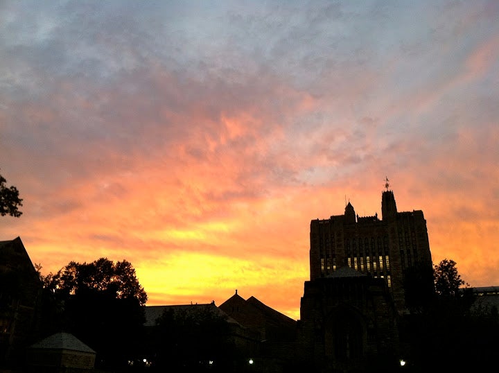 Sterling Memorial Library silhouetted against the sunset.