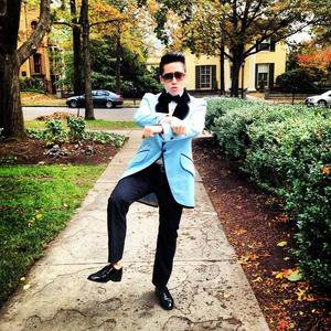 The author in costume as PSY, doing the &quot;Gangname Style&quot; dance.