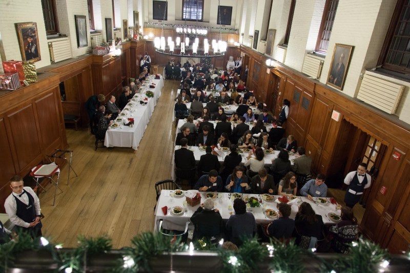 Students in formal attire dining in Timothy Dwight dining hall.