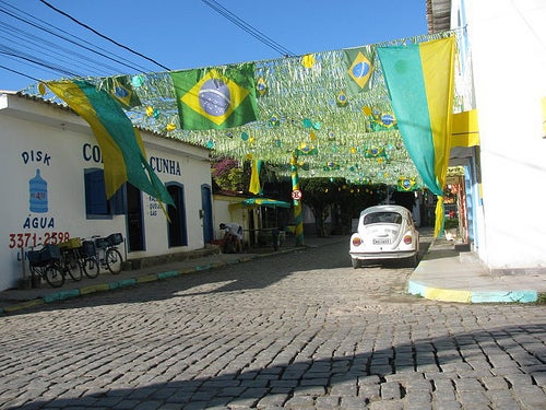 A street in Paraty with Brazillian flags and banners hung all the way down the road.