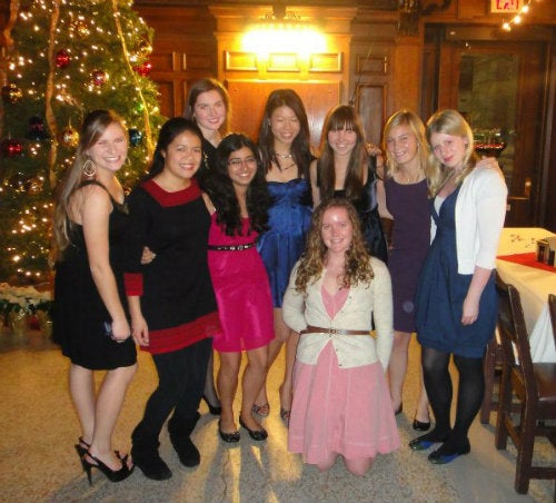 A group of girls taking a photo together at the freshman college holiday dinner
