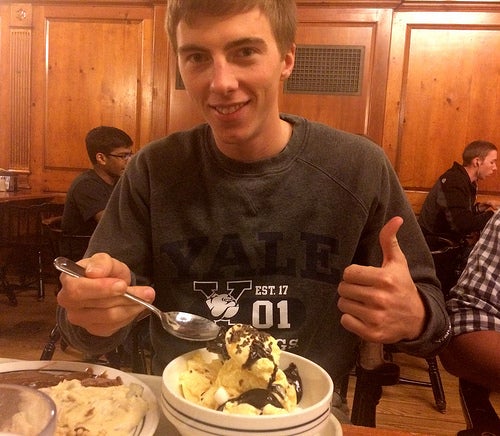A Timothy Dwight college student gives  a thumbs-up to an enormous sundae.