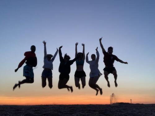 students jumping in silhouette