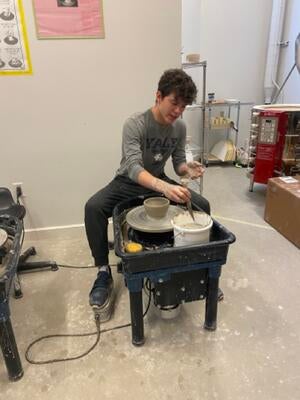 Aaron doing pottery wheel