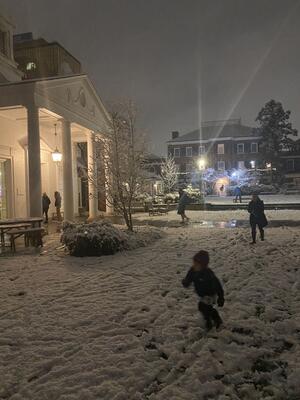 Children running in the snow in TD Courtyard