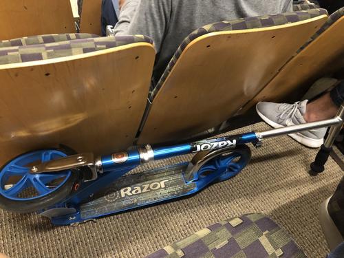 folded up scooter in lecture