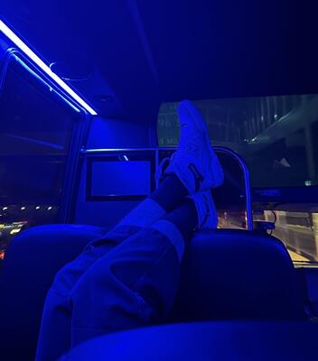 Someone sleeping on the minibus with their feet kicked up on the seat on our way back to New Haven, illuminated in color