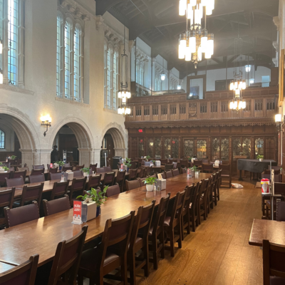 Trumbull dining hall with dark wood tables and white stone carved walls. 