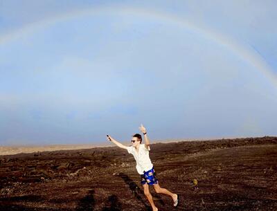 Boy chasing a rainbow
