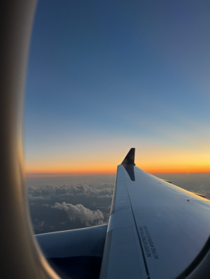 Warm and serene sunset seen through a window seat on a plane