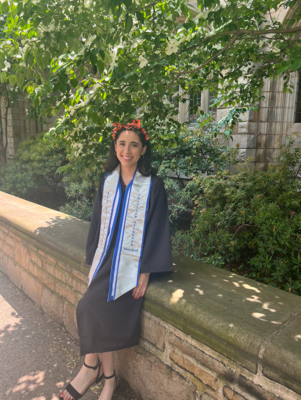 A girl in a cap and gown and butterfly headband