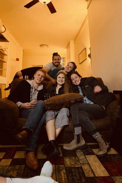 4 people smile on couch