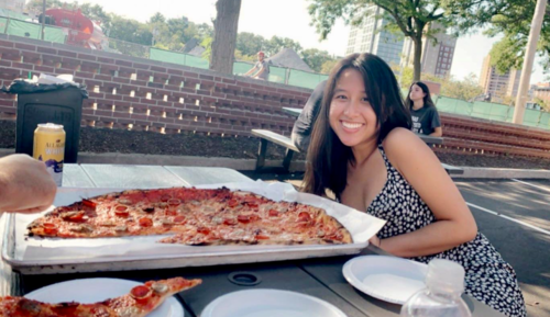 My friend and posing in front of Sally's pizza