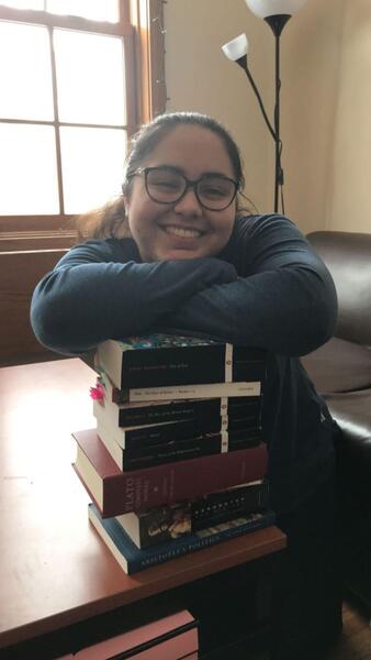 girl smiles with books