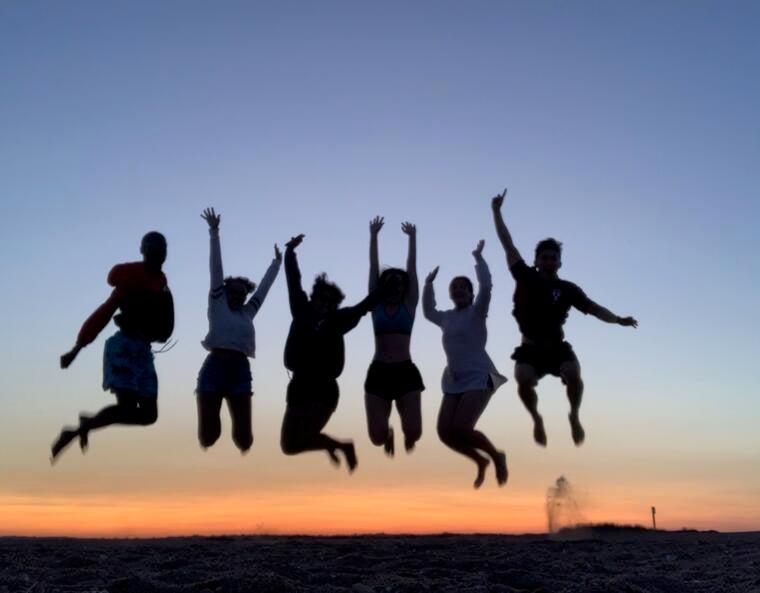 students jumping in silhouette