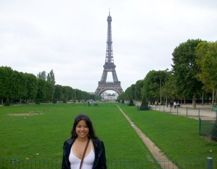 A Yale student, with the Eiffel Tower standing tall in the background.