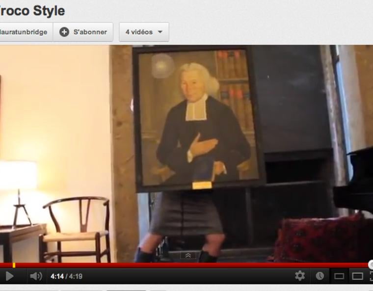 A person dancing, covered above the waist by a painting of Ezra Stiles.