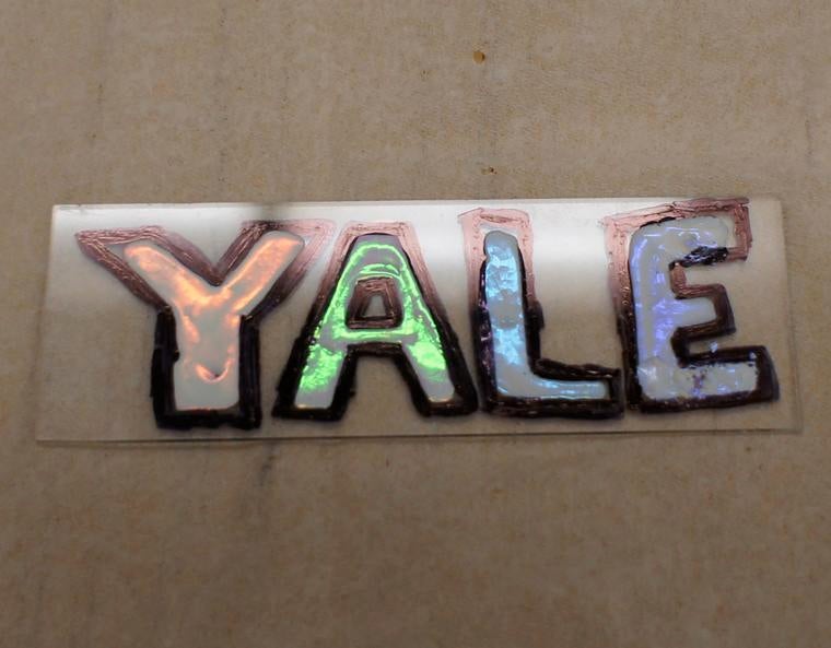 "YALE", written in a colorful substance resembling paint.