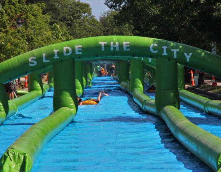 Children sliding down the world's longest inflatable water slide.
