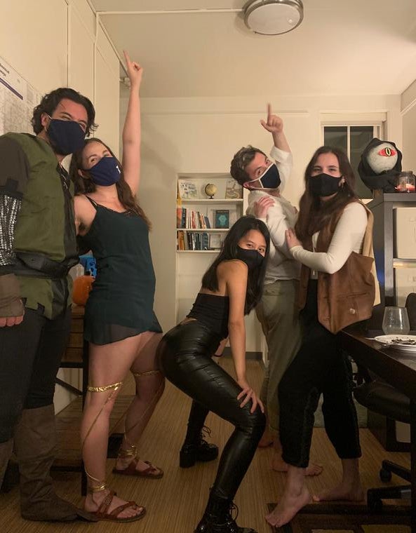 5 people pose in masks