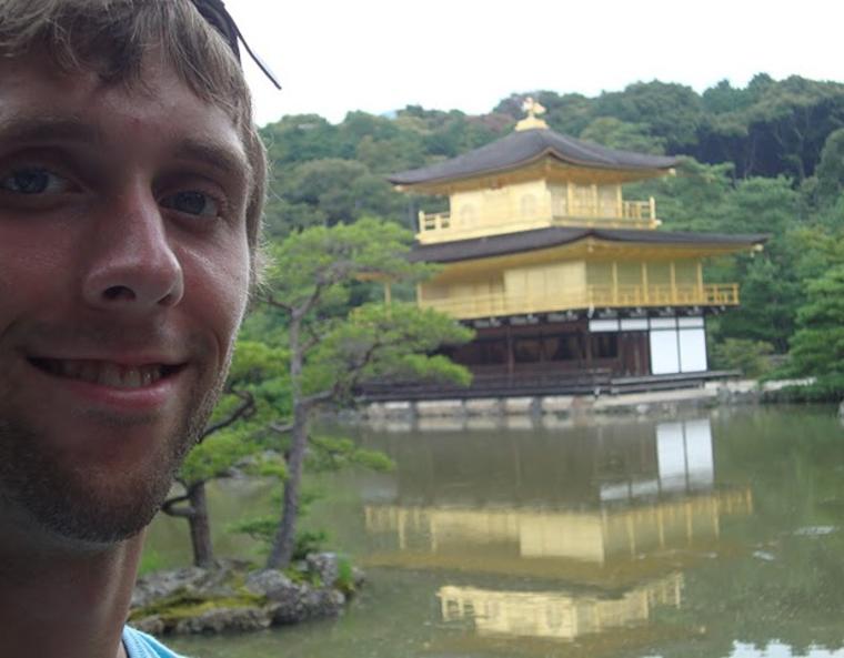 The author smiling with a Japanese pagoda in the background.